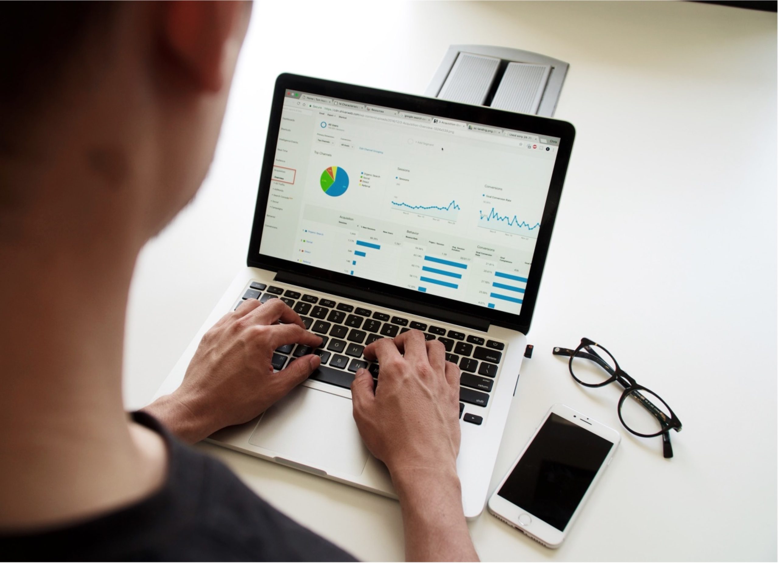 Man looking at statistics on laptop